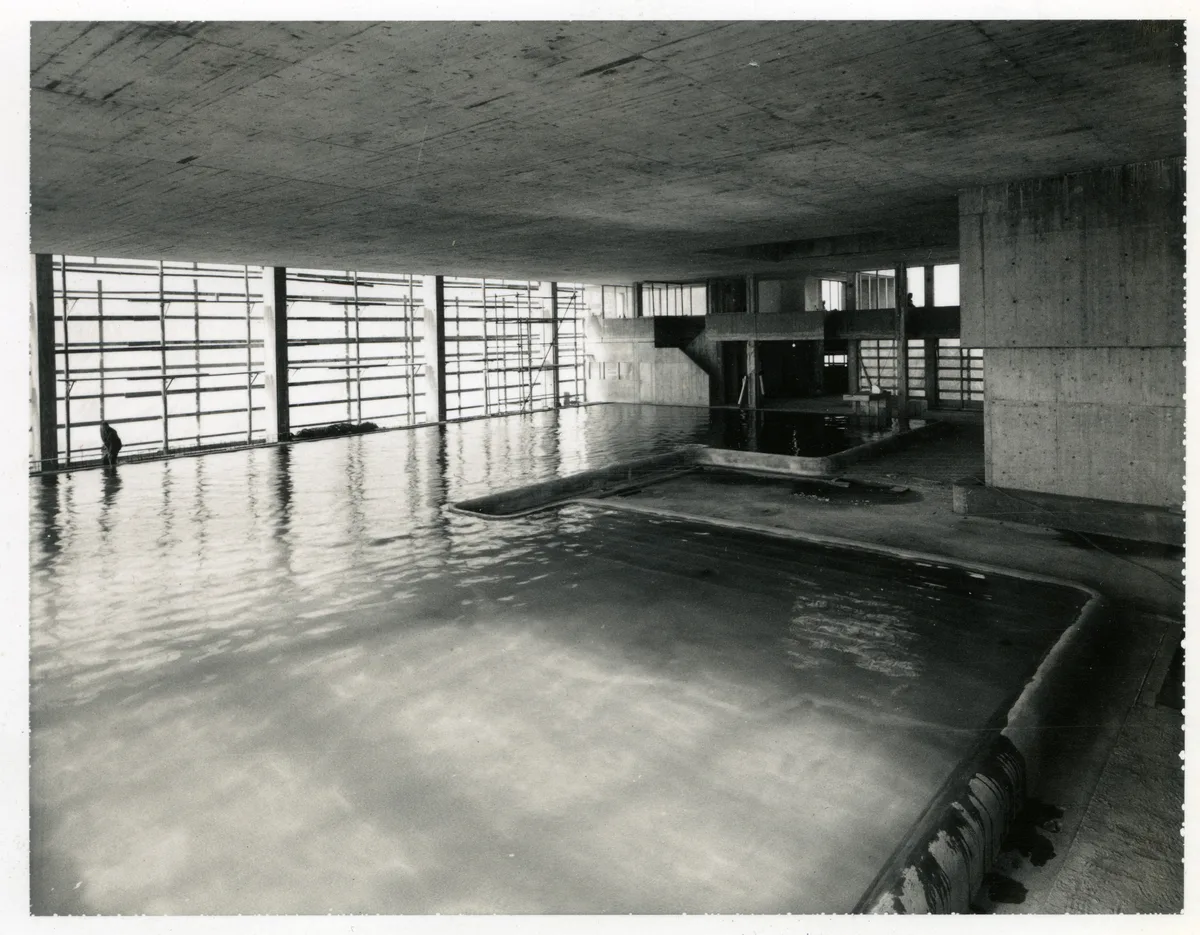 Das Ustermer Hallenbad Buchholz während der Bauphase 1972. Die schwere Betondecke stürzte 13 Jahre später aufs Bassin. Man sieht ein Hallenbad, in dem Bauarbeiten ablaufen.
